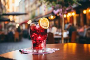 A glass of cold fresh sangria on a table on a cafe terrace photo