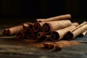 heap of canela cinnamon sticks close up on a wooden table in a dark key photo