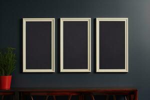 Three empty mockup frames on a dark gray wall over the wooden table photo