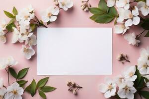 mockup white blank card sheet of paper on pink background with cherry flowers top view photo