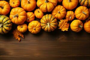 Top view of many delicious ripe pumpkins on wooden table with copy space. Autumn, thanksgiving and halloween concept. photo