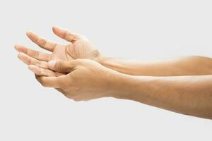 Pain in the palm of hand caused by bruising or injuring, Isolated on a gray wall background. photo