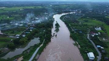 Aerial view of water released from the drainage channel of the concrete dam is a way of overflowing water in the rainy season. Top view of turbid brown forest water flows from a dam in Thailand. video