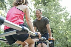 Man and woman exercising on a fitness trail photo