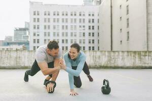 Man and woman high five while exercising in the city, Vancouver, Canada photo