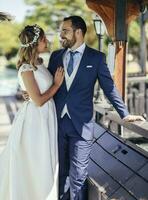 Bridal couple enjoying their wedding day in a park photo