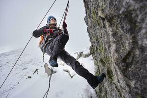 Mature woman climbing at Grossvendediger, Tyrol, Austria photo