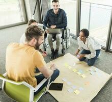 Happy young business people working together on a project in office photo