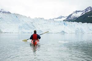 USA, Alaska, Valdez, man in canoe on glacial lake photo