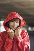 Woman wearing red rain coat, portrait photo