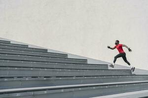 Sportsman wearing face mask running up stairs photo