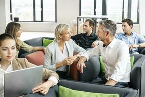 Business people meeting in sitting corner, talking photo