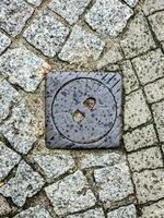 Manhole cover of the gas pipeline system. A massive metal hatch for access to city communications in the pavement. photo