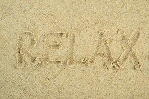 relax written on the beach photo