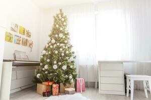 christmas room interior tree decorated by lights gifts toys candles holiday concept photo