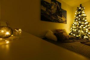 Illuminated Christmas tree decorated in modern living room photo