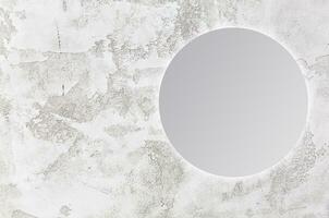 round mirror on gray background photo