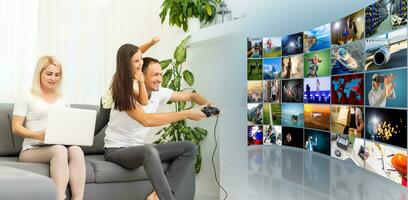 Young family having fun playing videogames on a huge screen at home photo