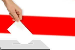 hand drops the ballot election against the background of the flag, concept of state elections, referendum photo