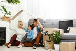 concept housing a young family. Mother father and child in new house with a roof at a home photo