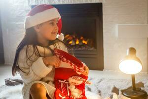 Cute little girl in the santa claus hat photo