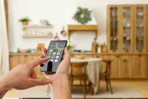 smart house, home automation, device with app icons. Man uses his smartphone with smarthome security app to unlock the door of his house. photo