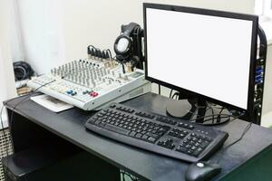 Laptop Samsung notebook on a desk. Dark screen, no signal. DJ mixer for playing music, headphones photo