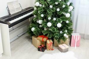 A piano with christmas lights and tree photo