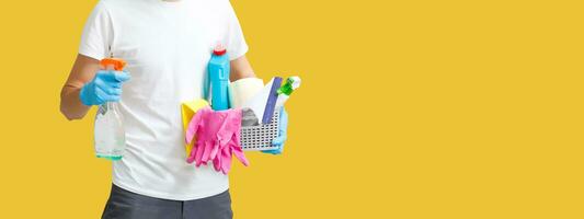 man doing apartment cleaning. Infection prevention and control of epidemic. Protective gloves and mask. yellow background photo