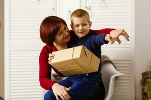 Woman and boy checking christmas presents photo