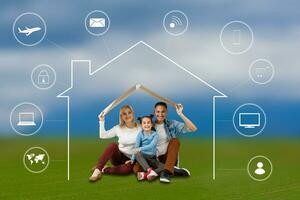 Happy family sitting her children playing under smart house design at field photo