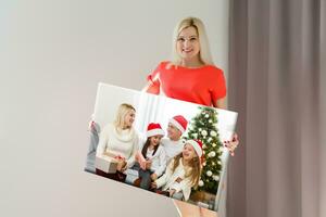 Canvas prints. A woman holding photo canvas. photo printed on glossy synthetic canvas and stretched on wooden stretcher bar