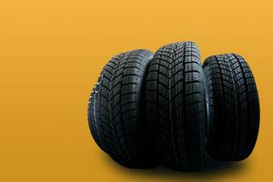 Car tires isolated on yellow background photo