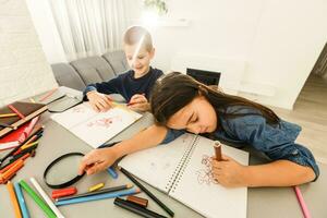 educación, elemental escuela, aprendizaje y personas concepto - grupo de colegio niños con plumas y cuadernos escritura prueba en salón de clases foto