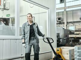 Industry, woman using pallet jack photo