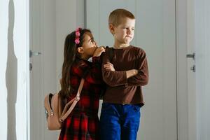 School friends bullying a sad girl in corridor at school photo