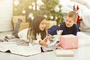 Christmas Kids. Happy Children Opening Gifts. New Year. Christmas Tree photo