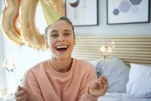 Cheerful woman during her birthday with sparklers photo