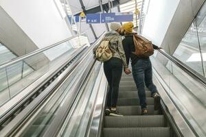 Young couple kissing on an escalator at the station, Berlin, Germany photo