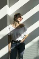 Portrait of laughing young woman with red lips and sunglasses photo