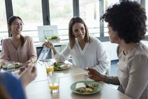 Businesswomen during lunch in an office photo