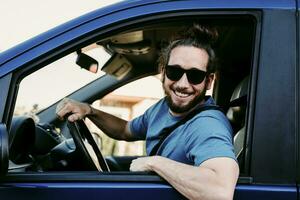 Portrait of happy man in car photo