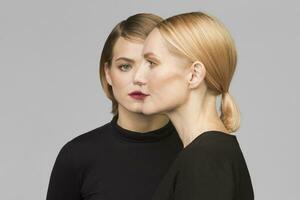 Studio portrait of mother and adult daughter photo