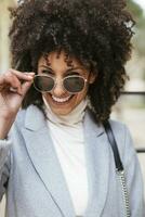 Portrait of happy woman wearing sunglasses photo