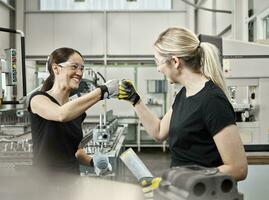 Two woman at work, fist bump photo