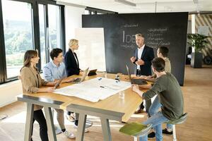 Business people having a workshop in office, discussing plans photo