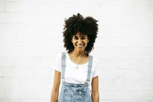 Portrait of laughing woman in front of white wall photo