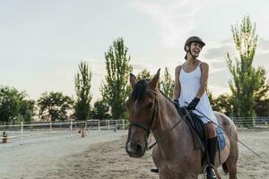 Laughing woman on horse photo