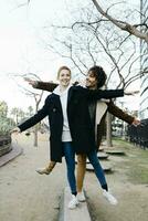 Happy couple balancing in a city park photo