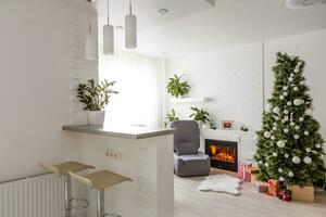 Fireplace and Christmas tree with presents in living room photo